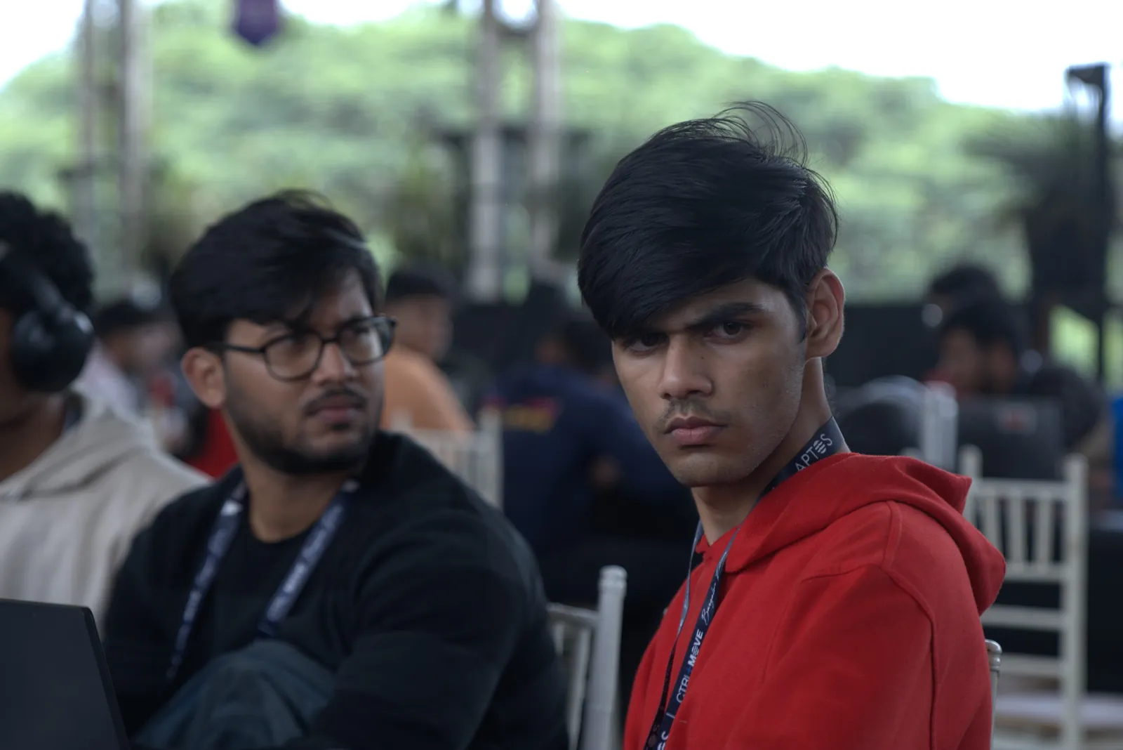 Teammates at a hackathon, one looking at the camera