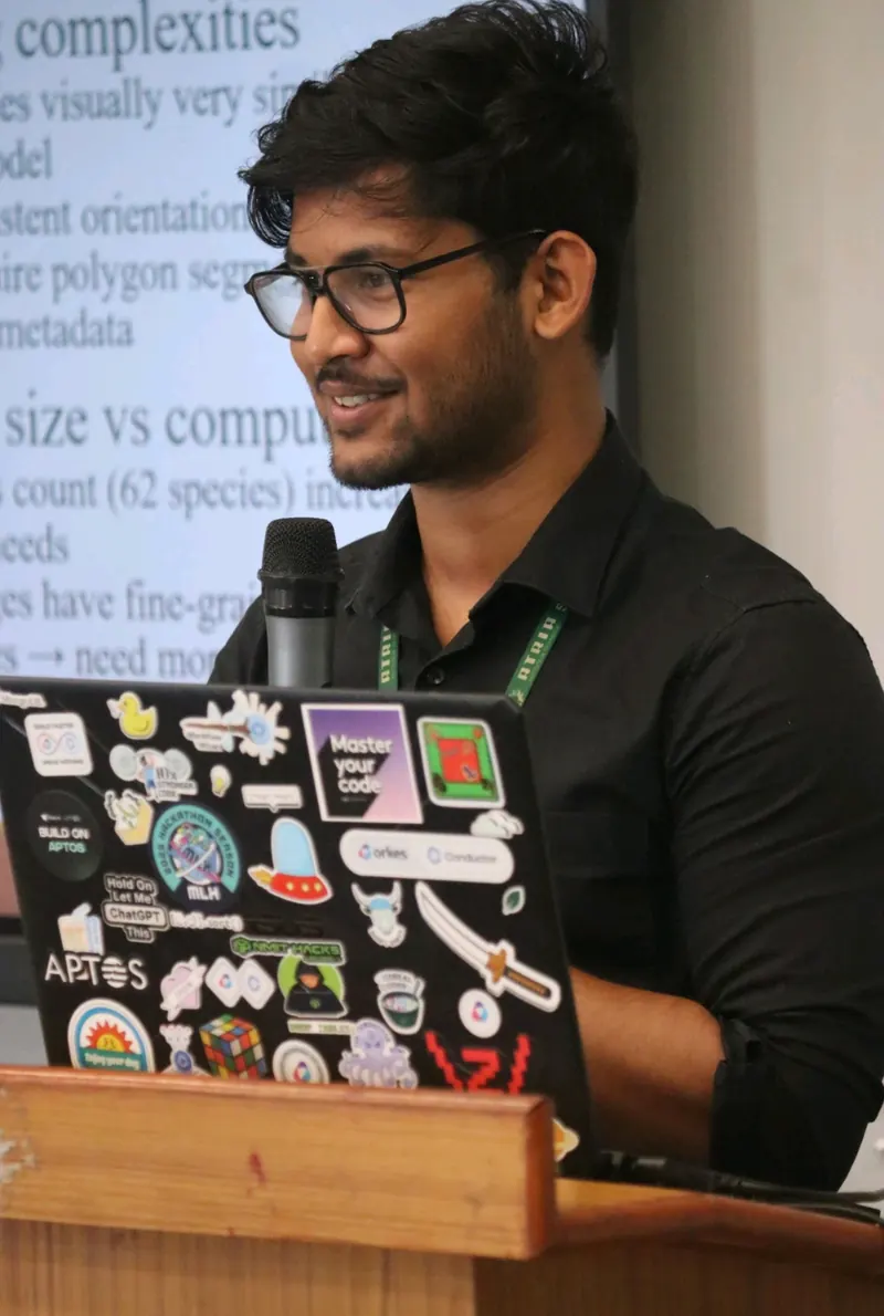Ujesh speaking into a microphone